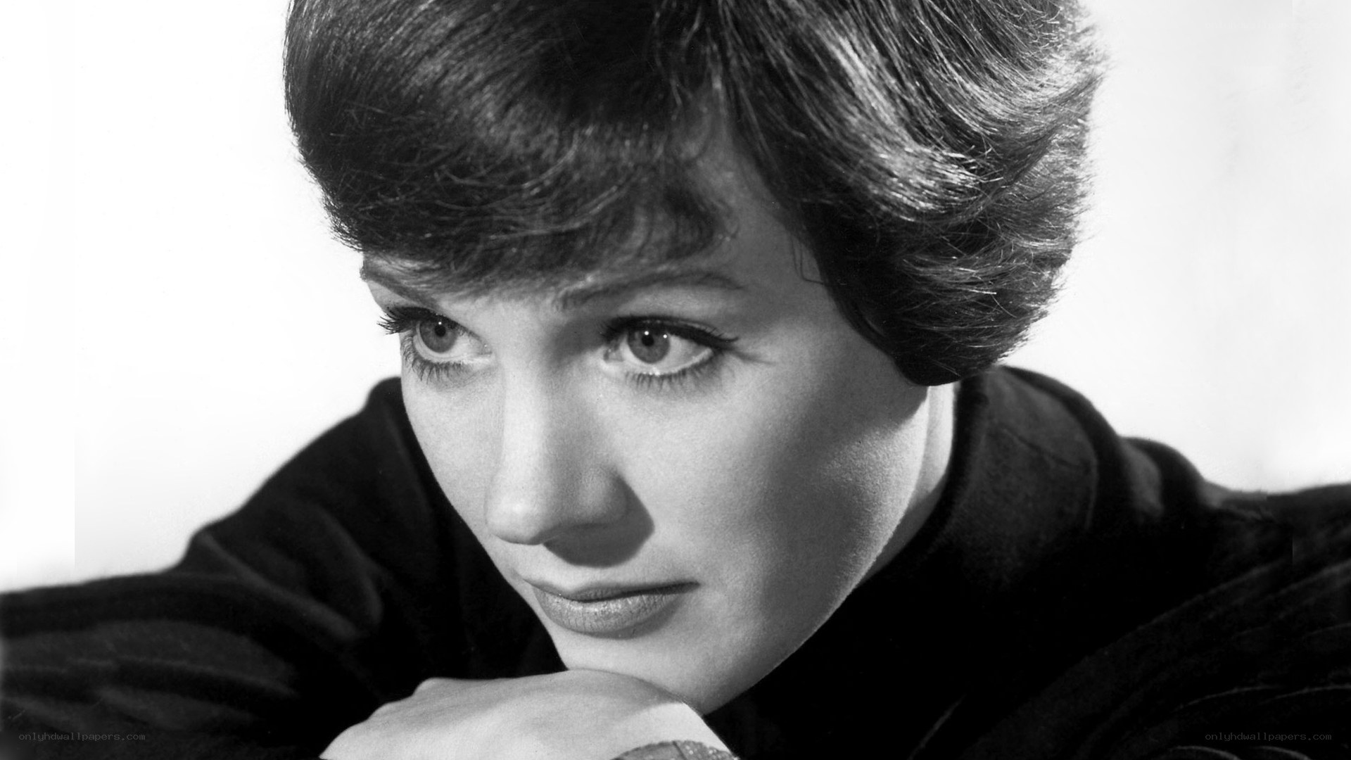 woman with short hair resting chin
