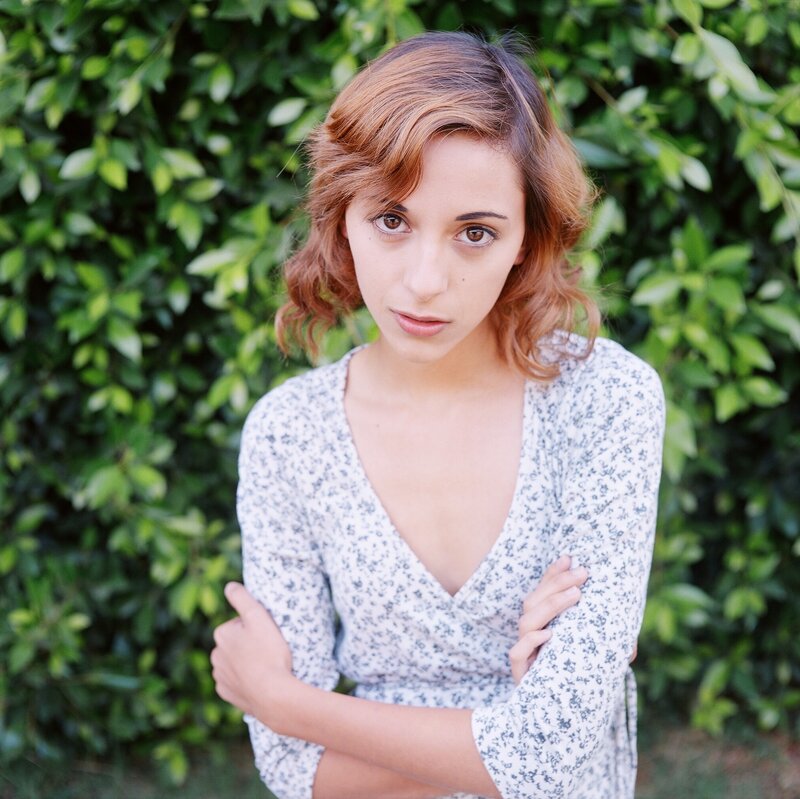 woman with short hair standing outside