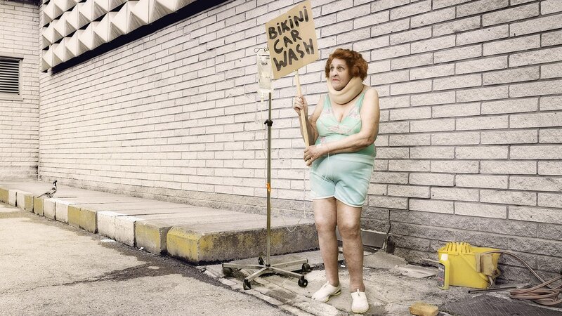 Woman with sign and IV stand