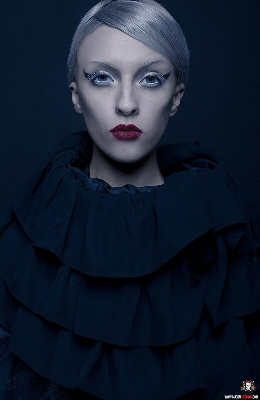 woman with silver hair and dramatic makeup