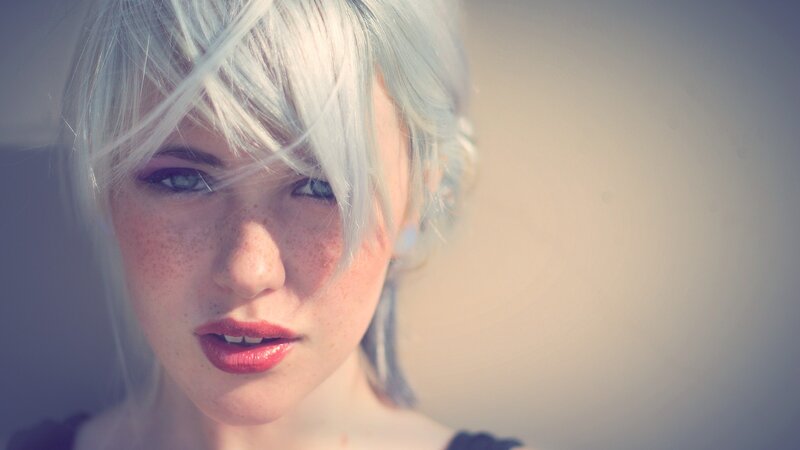 woman with silver hair and freckles