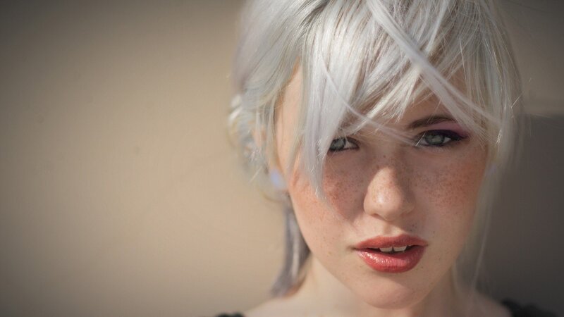 woman with silver hair and freckles