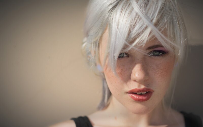 woman with silver hair and freckles