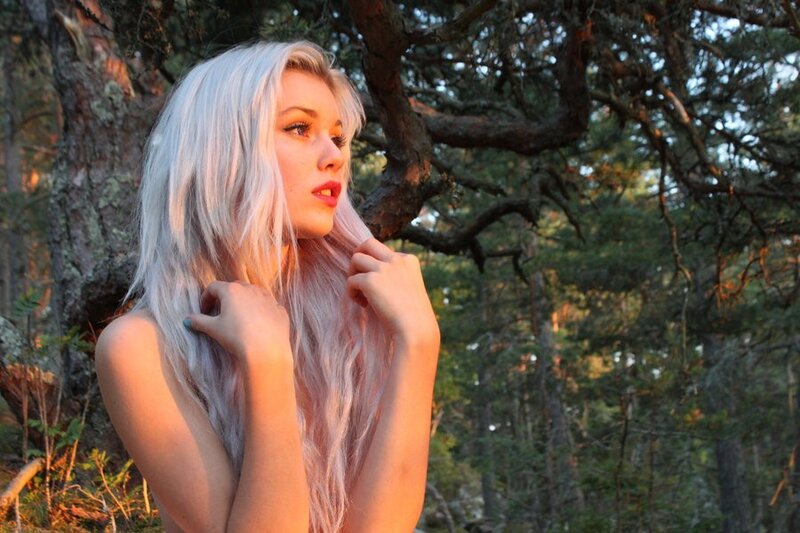 woman with silver hair in forest