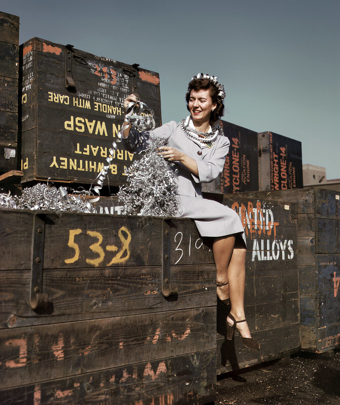Woman with silver tinsel on crate