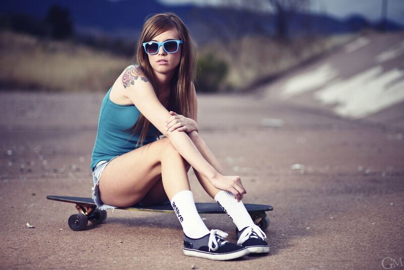 woman with skateboard and sunglasses