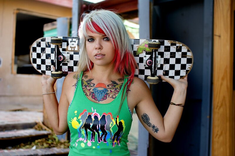 woman with skateboard and tattoos