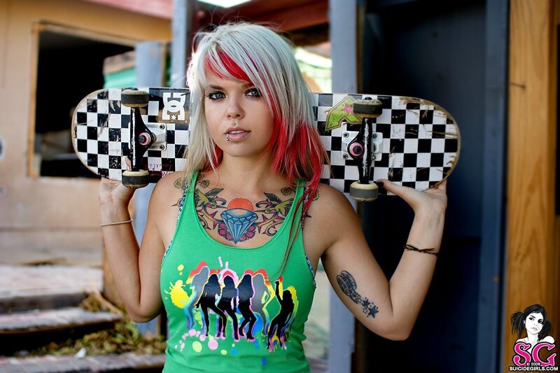 Woman with skateboard and tattoos