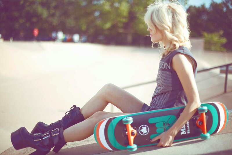 woman with skateboard at skatepark