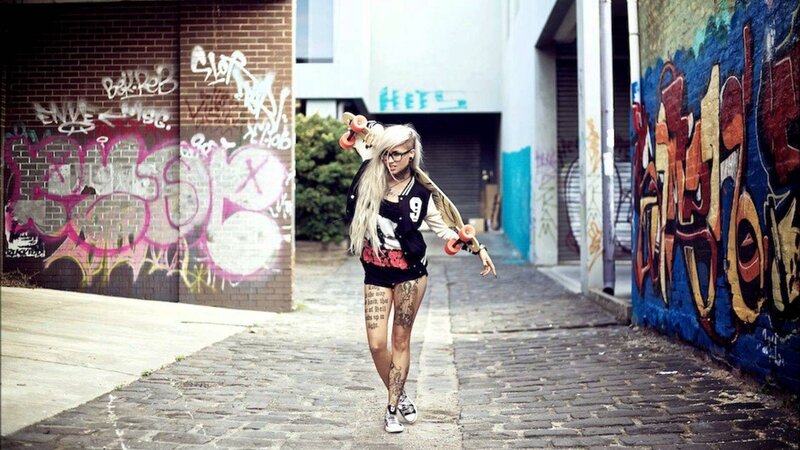 woman with skateboard in alley