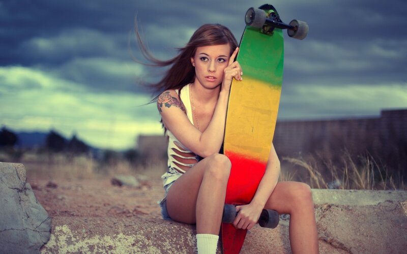 woman with skateboard on concrete