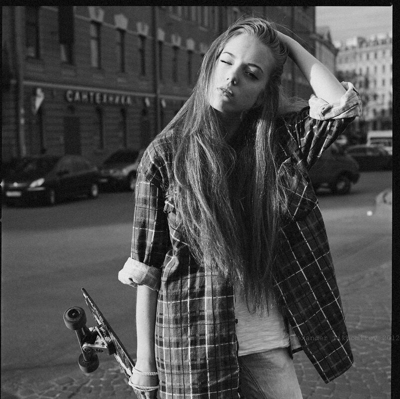 woman with skateboard on street
