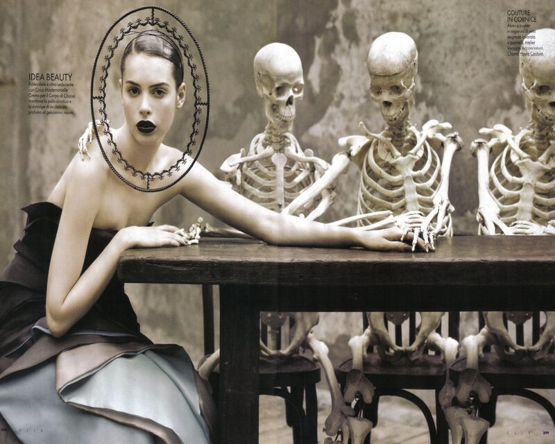 woman with skeletons at table