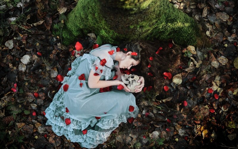 Woman with skull in forest