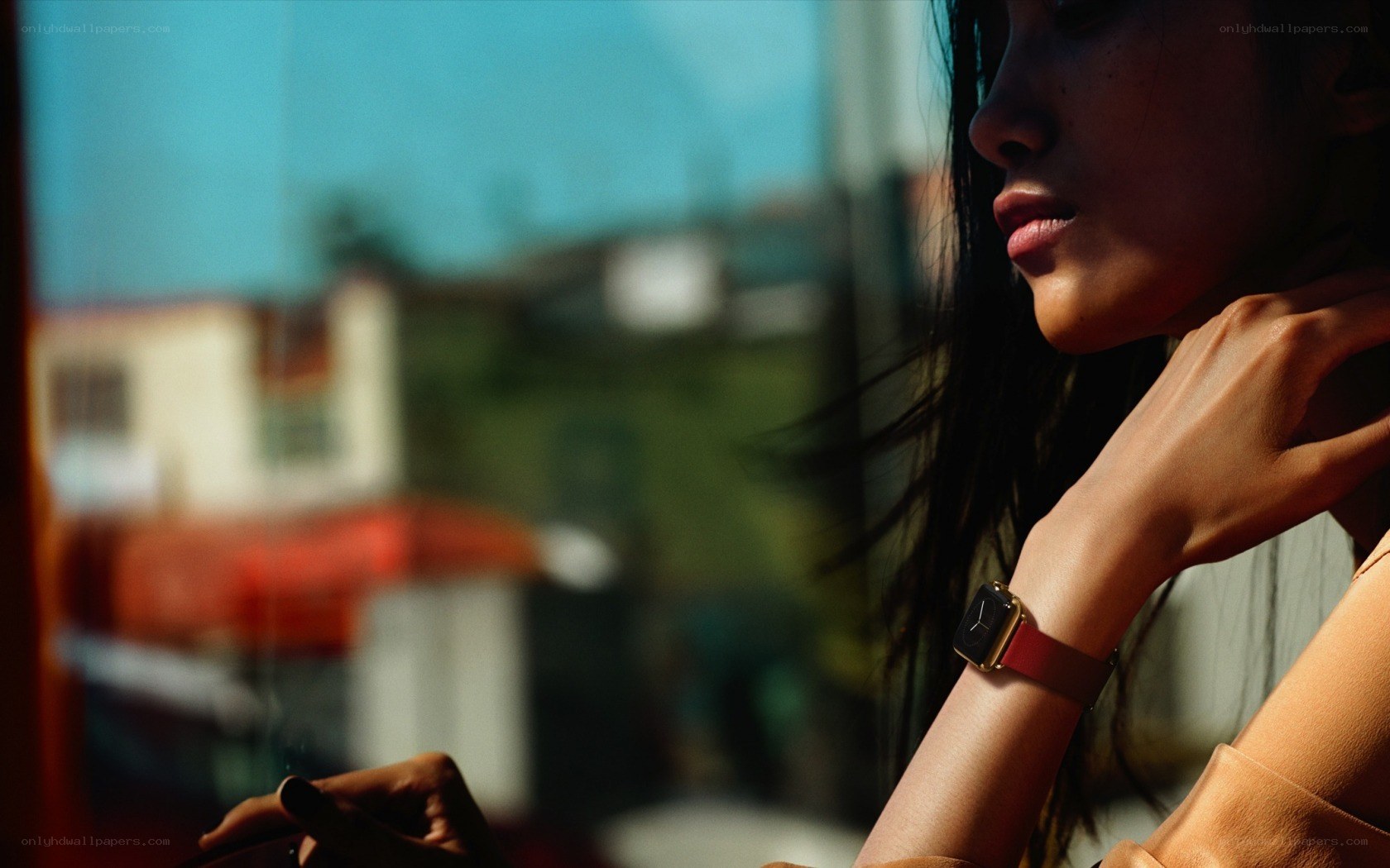 woman with smartwatch by window