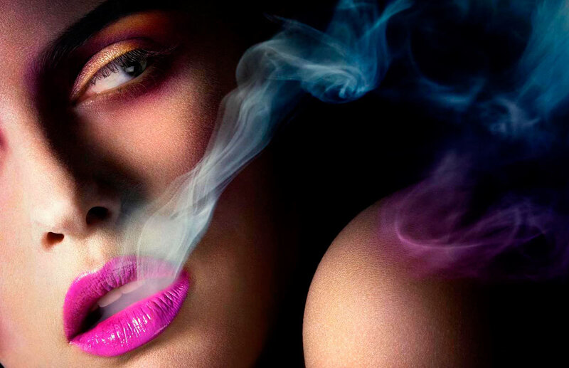 woman with smoke and vibrant makeup