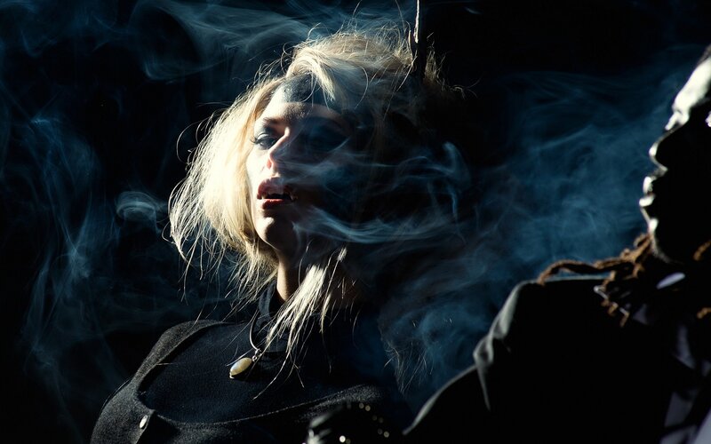 woman with smoke in dark setting