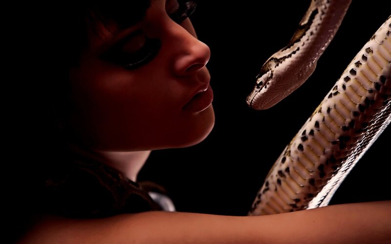 woman with snake in dark room