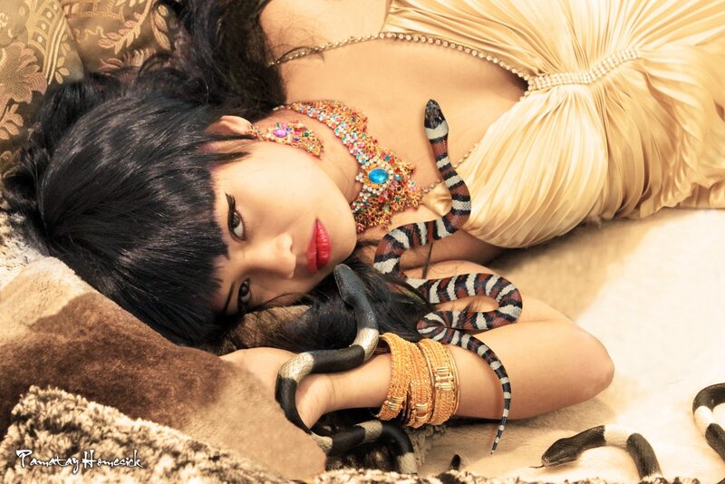 woman with snake on bed