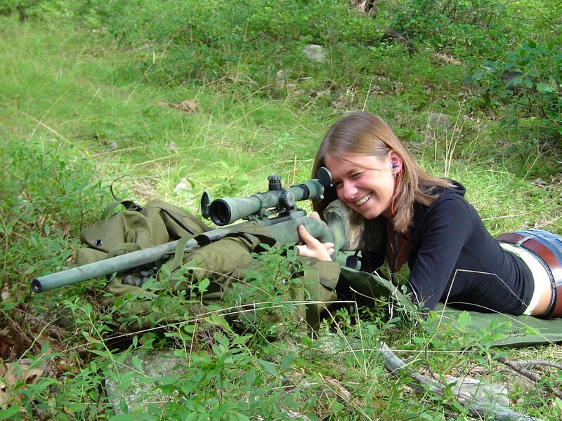 woman with sniper rifle in field