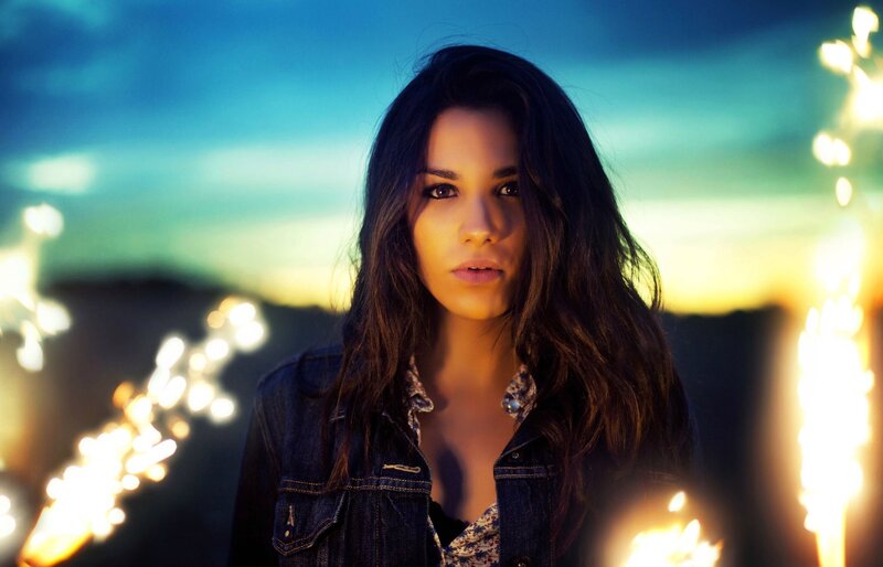 woman with sparklers at dusk
