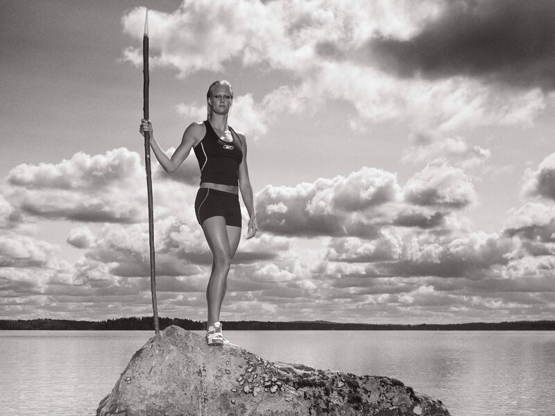 Woman with spear on rock