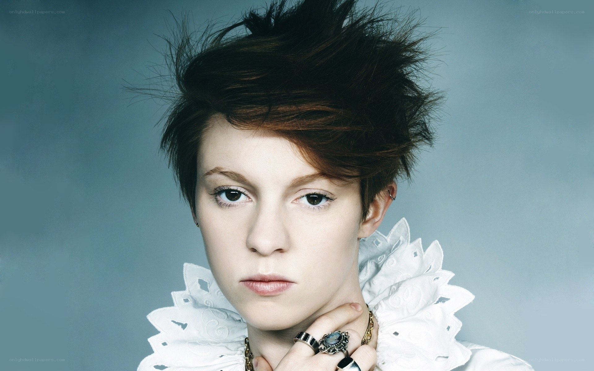 woman with spiky hair and ruffled collar