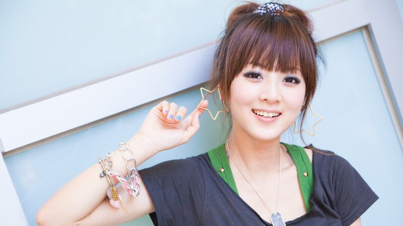 woman with star earrings smiling
