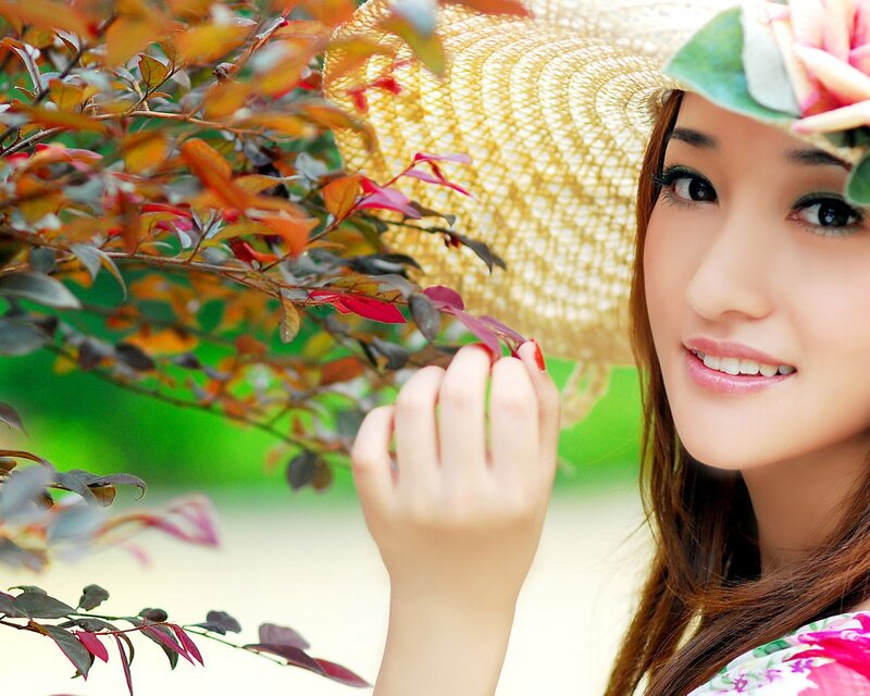 woman with straw hat and flowers