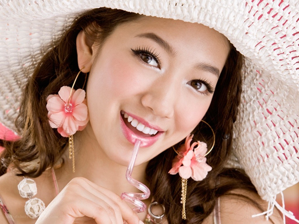 woman with straw hat drinking