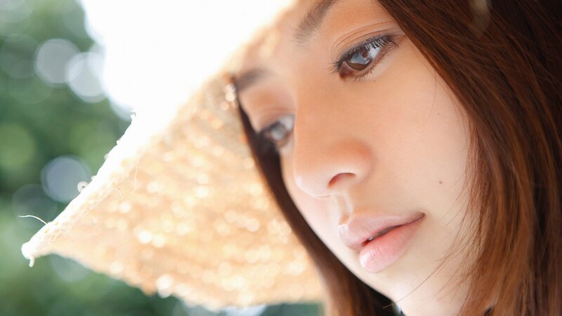 woman with straw hat in sunlight