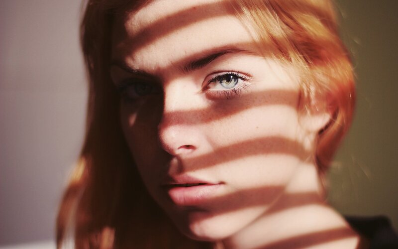 woman with striped light on face