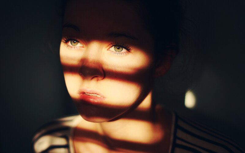 woman with striped light on face