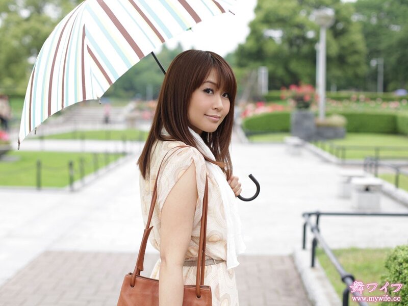 Woman with striped umbrella in park