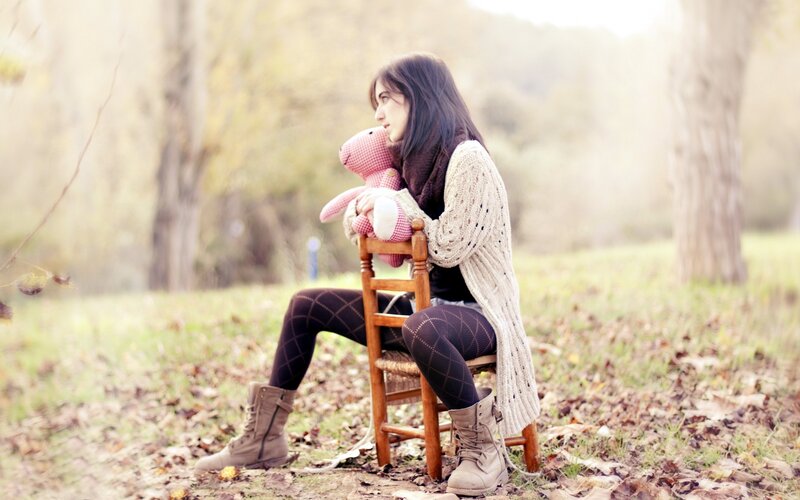 woman with stuffed animal in park