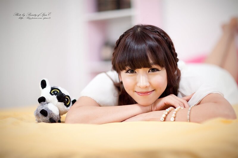 woman with stuffed animal on bed