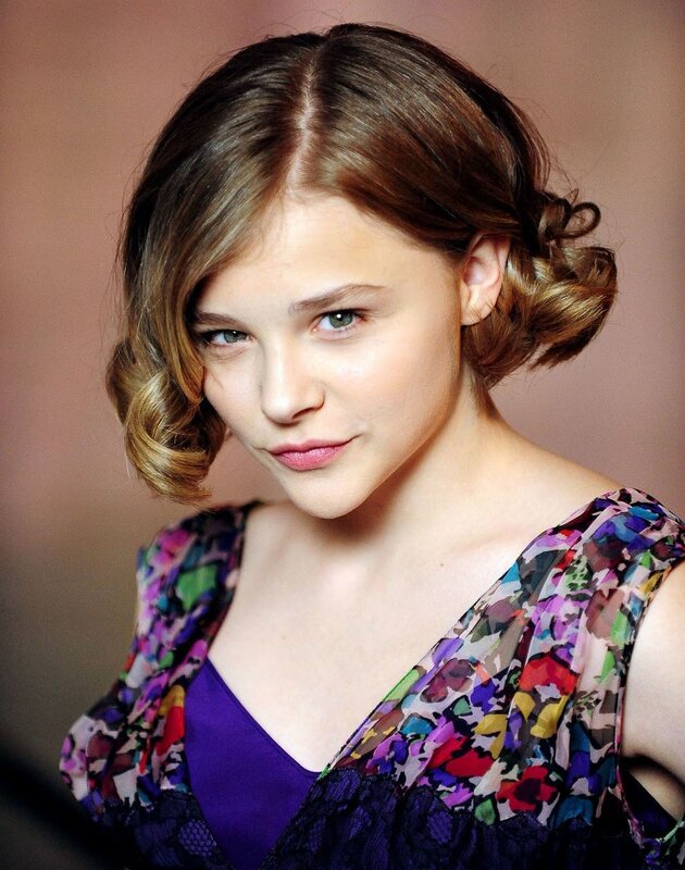 woman with styled hair and colorful top