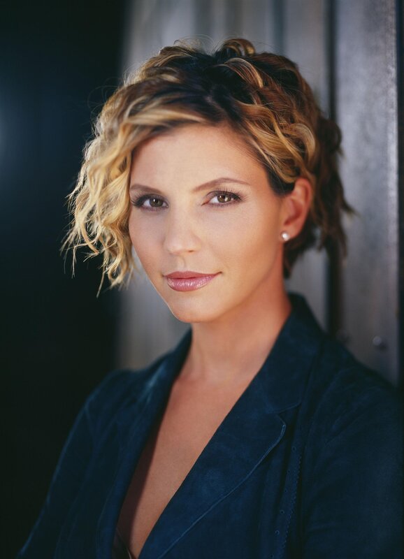 woman with styled hair in dark jacket