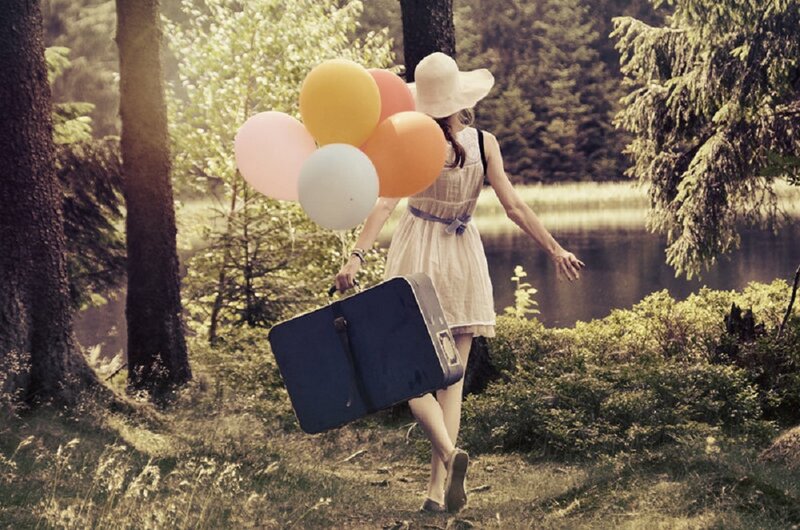 Woman with Suitcase and Balloons