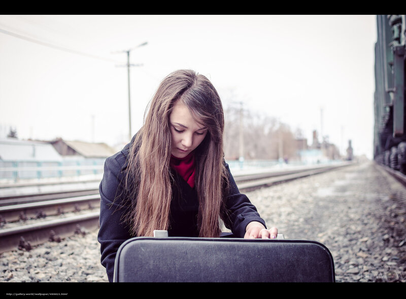 woman with suitcase at train station