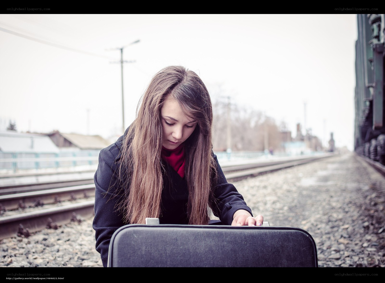 woman with suitcase at train station