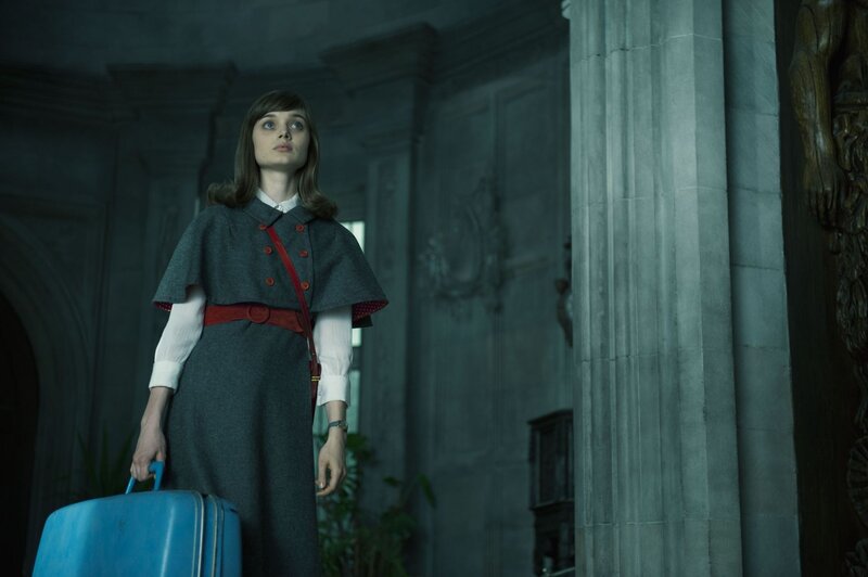 woman with suitcase in grand hall