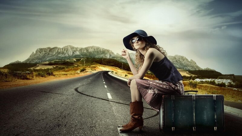 woman with suitcase on road