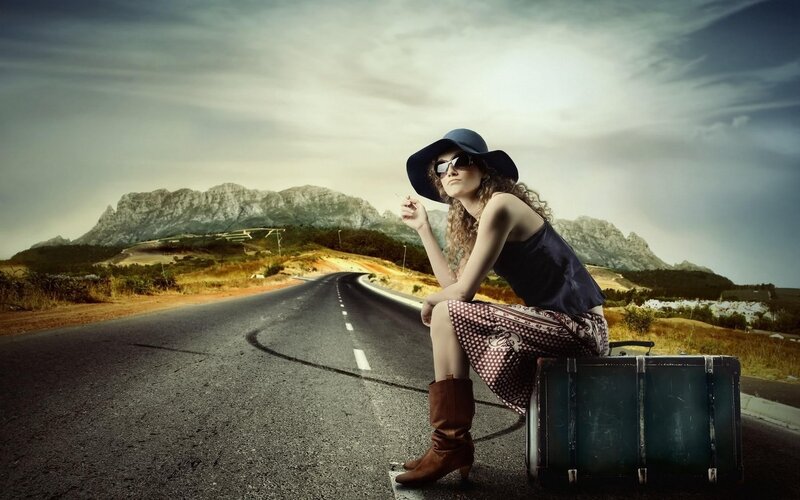 woman with suitcase on road