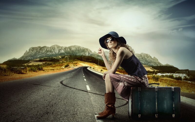 woman with suitcase on road