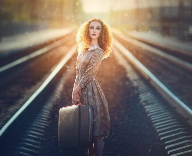 Woman with Suitcase on Tracks