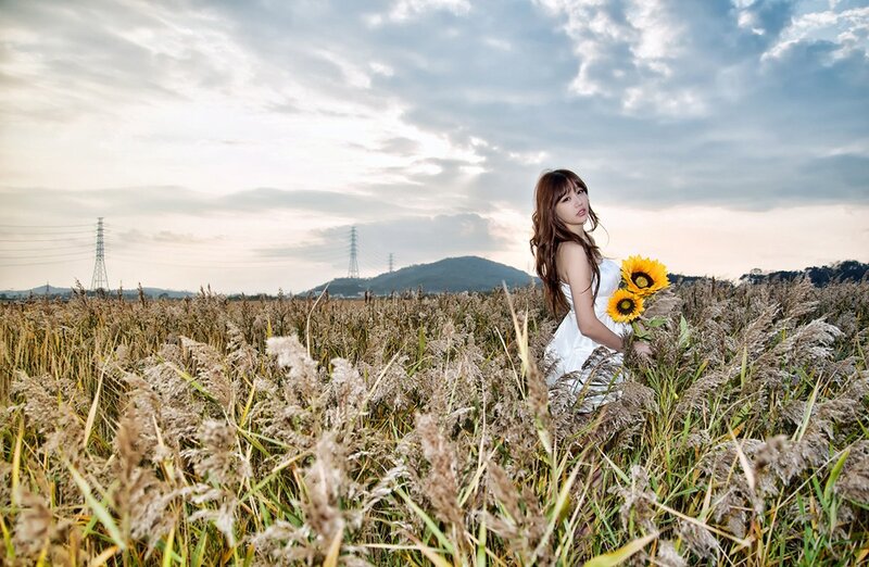 Woman with sunflowers in a field