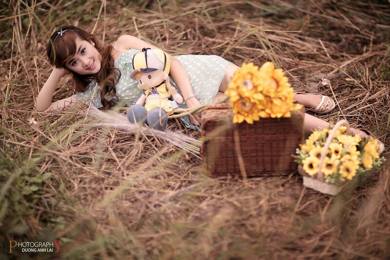 Woman with sunflowers in field