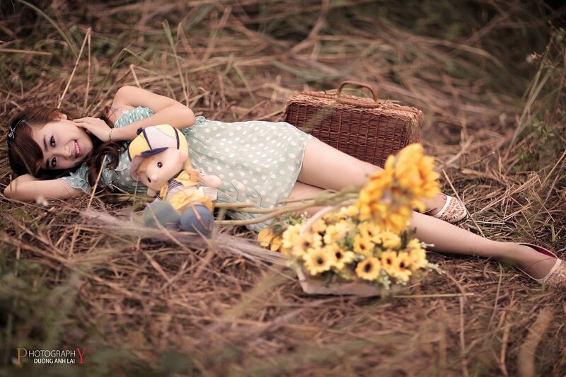 Woman with sunflowers in field
