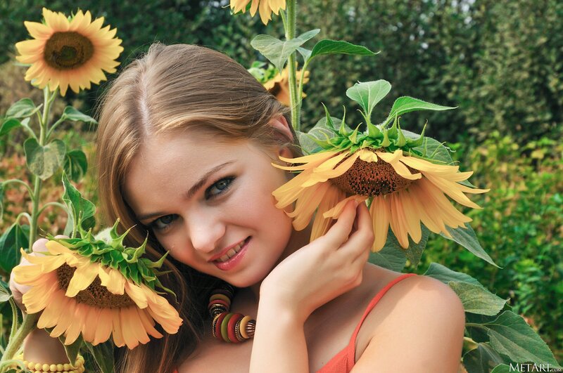 woman with sunflowers in field